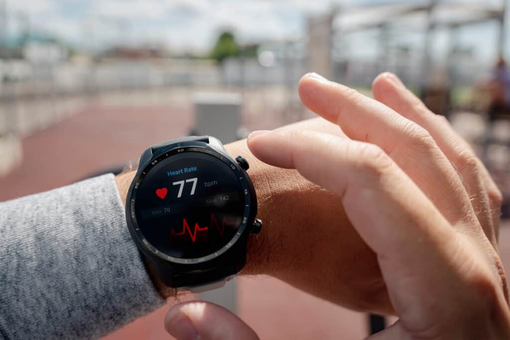 Close-up of smart watch health tracker with the heart rate shown on the screen